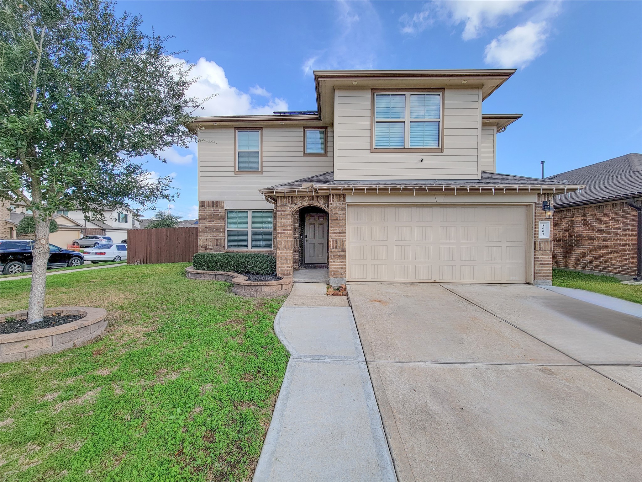 8003 Ecru Lane Rosharon, TX 77583 - Photo 5 of 36 a front view of a house with a yard and garage