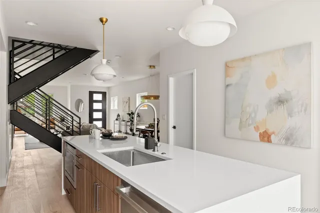a kitchen with kitchen island a dining table and chairs