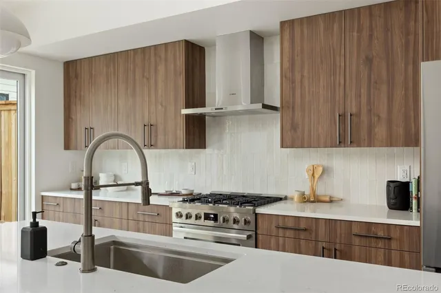 a stove top oven sitting inside of a kitchen