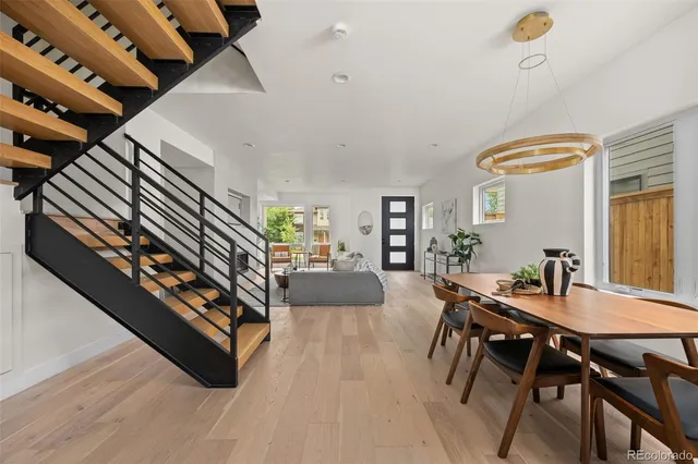 a bedroom with a large bed and a painting on the wall