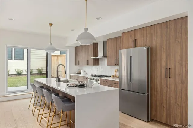 a kitchen with windows a sink and a stove