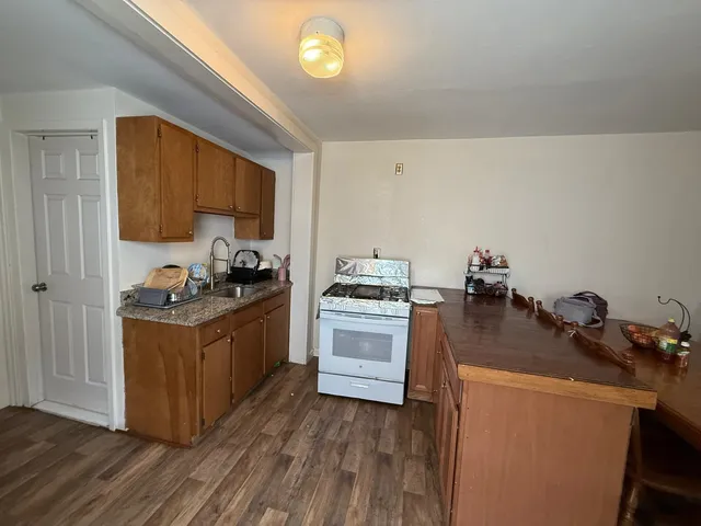 a kitchen with a stove a sink and a refrigerator