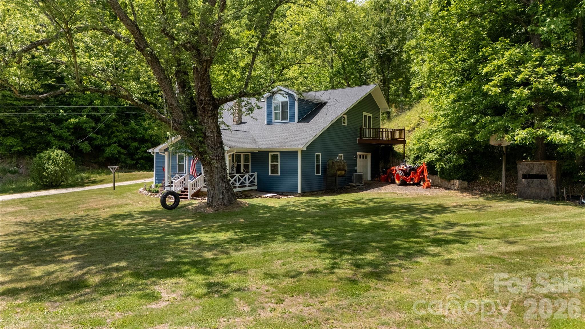 84 Sheets Farm Road Bakersville, NC 28705 - Photo 4 of 42 a view of a house with a yard and sitting area
