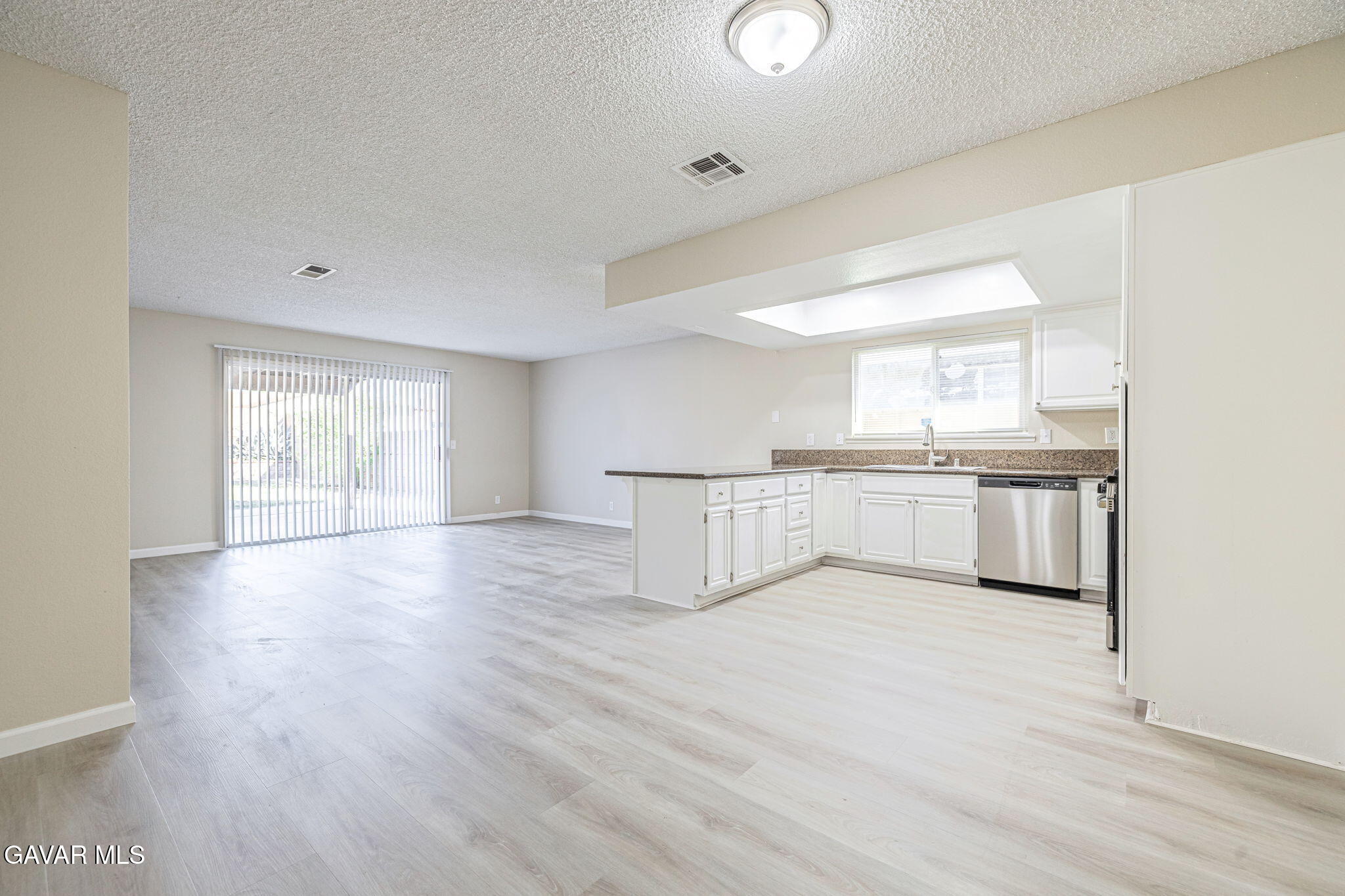44422 Sancroft Avenue Lancaster, CA 93535 - Photo 11 of 35 a view of a kitchen with wooden floor and electronic appliances