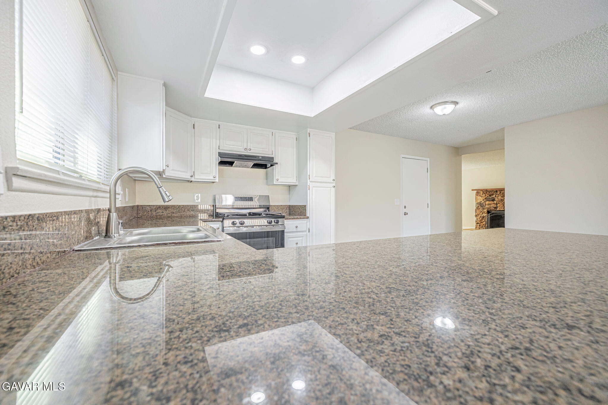 44422 Sancroft Avenue Lancaster, CA 93535 - Photo 16 of 35 a kitchen with granite countertop a sink stainless steel appliances and cabinets
