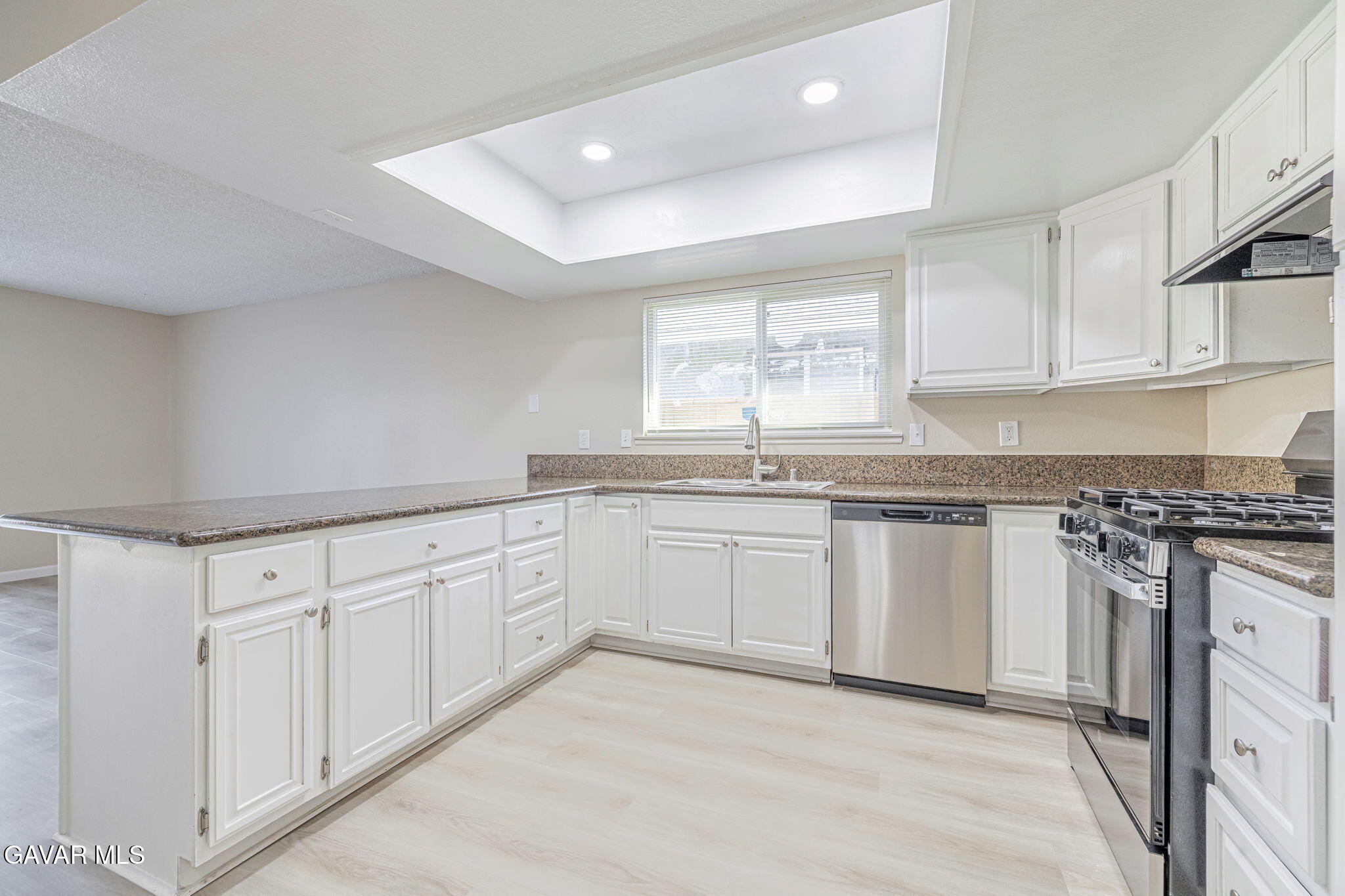 44422 Sancroft Avenue Lancaster, CA 93535 - Photo 17 of 35 a kitchen with granite countertop white cabinets and white appliances