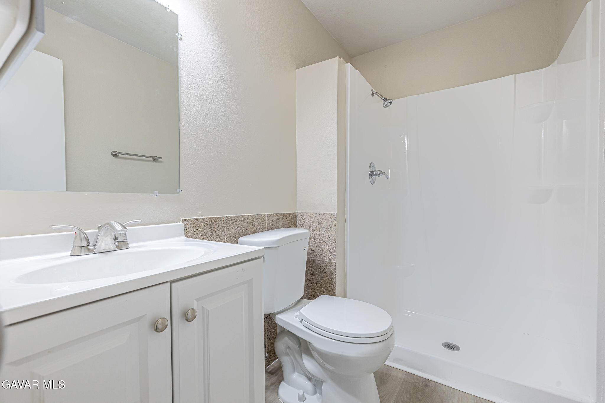 44422 Sancroft Avenue Lancaster, CA 93535 - Photo 26 of 35 a bathroom with a sink a toilet and a mirror