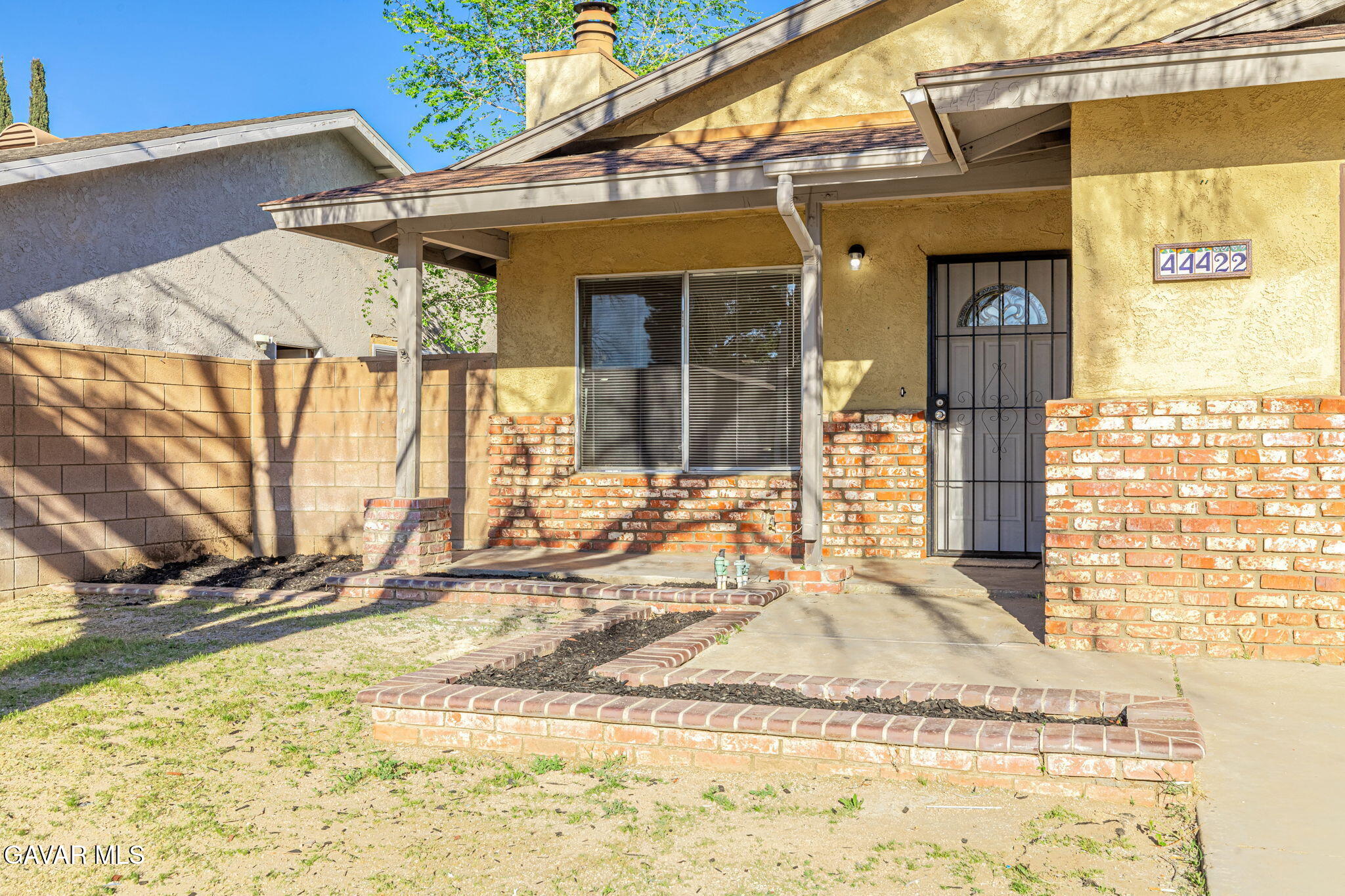 44422 Sancroft Avenue Lancaster, CA 93535 - Photo 4 of 35 a view of a brick house with large windows