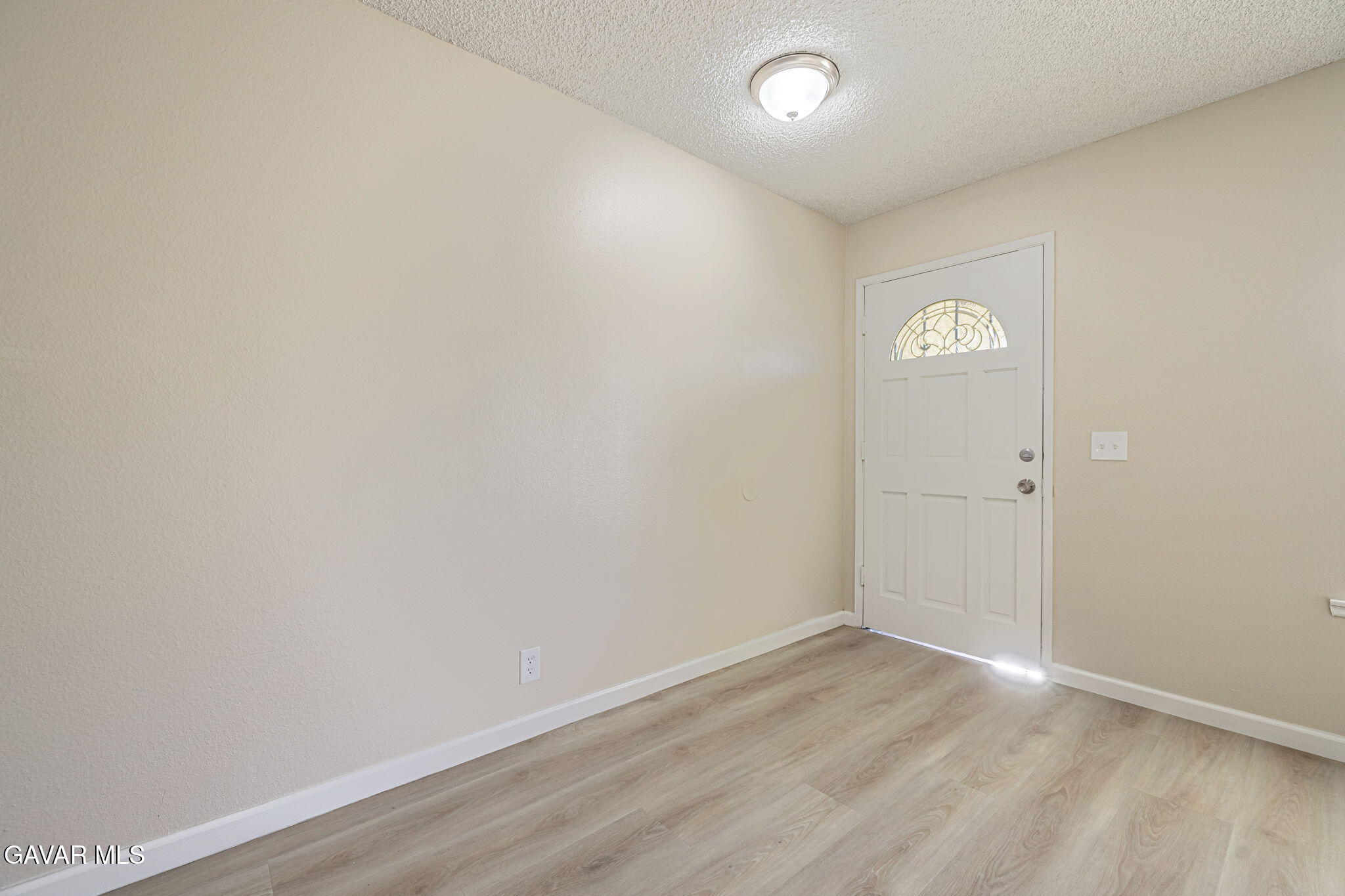 44422 Sancroft Avenue Lancaster, CA 93535 - Photo 8 of 35 an empty room with wooden floor and window