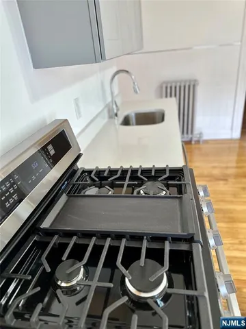 a stove top oven sitting inside of a kitchen