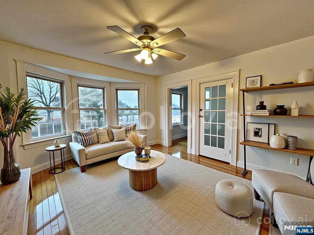 227 Hamilton Avenue, Unit 2 Hasbrouck Heights, NJ 07604 - Photo 4 of 27 a living room with furniture and a large window
