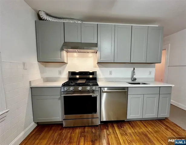 a kitchen with a stove and white cabinets