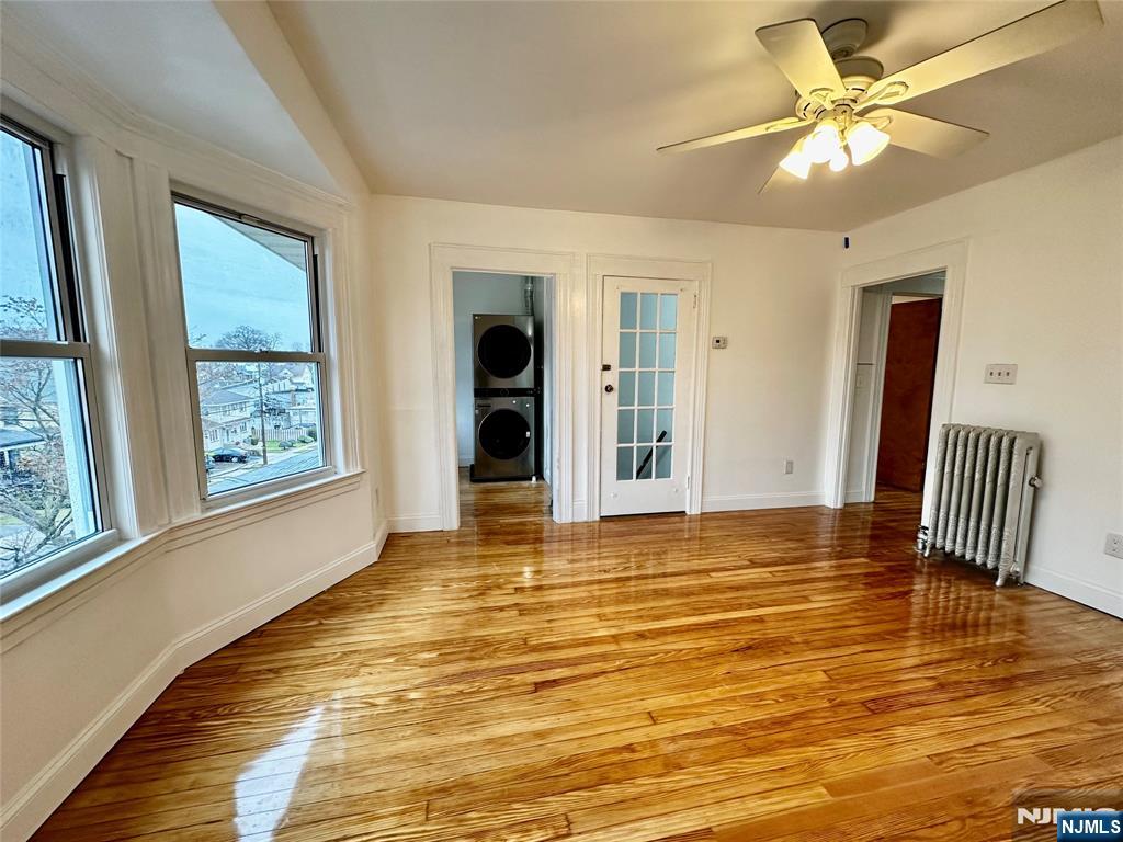 227 Hamilton Avenue, Unit 2 Hasbrouck Heights, NJ 07604 - Photo 7 of 27 a view of an empty room with window and a kitchen