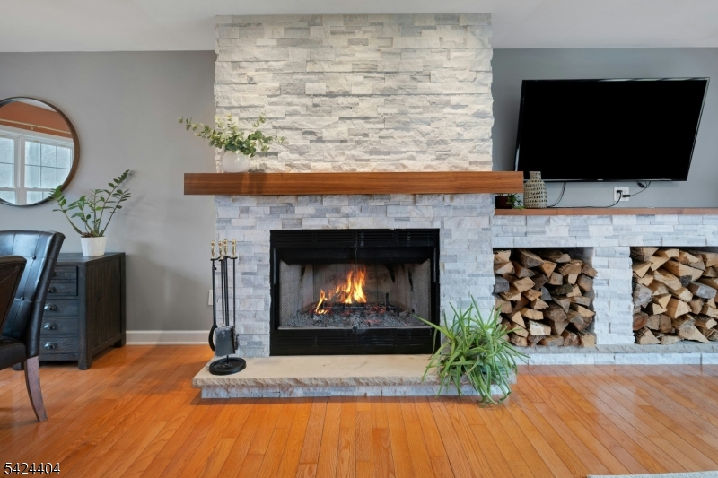 4 Andover Mohawk Road Sparta, NJ 07871 - Photo 15 of 35 a living room with a fireplace a flat screen tv and a fireplace