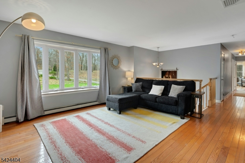 4 Andover Mohawk Road Sparta, NJ 07871 - Photo 17 of 35 a spacious bedroom with a bed a couch and a window