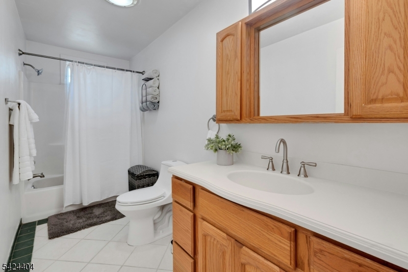 4 Andover Mohawk Road Sparta, NJ 07871 - Photo 22 of 35 a bathroom with a sink a toilet a mirror and shower curtain