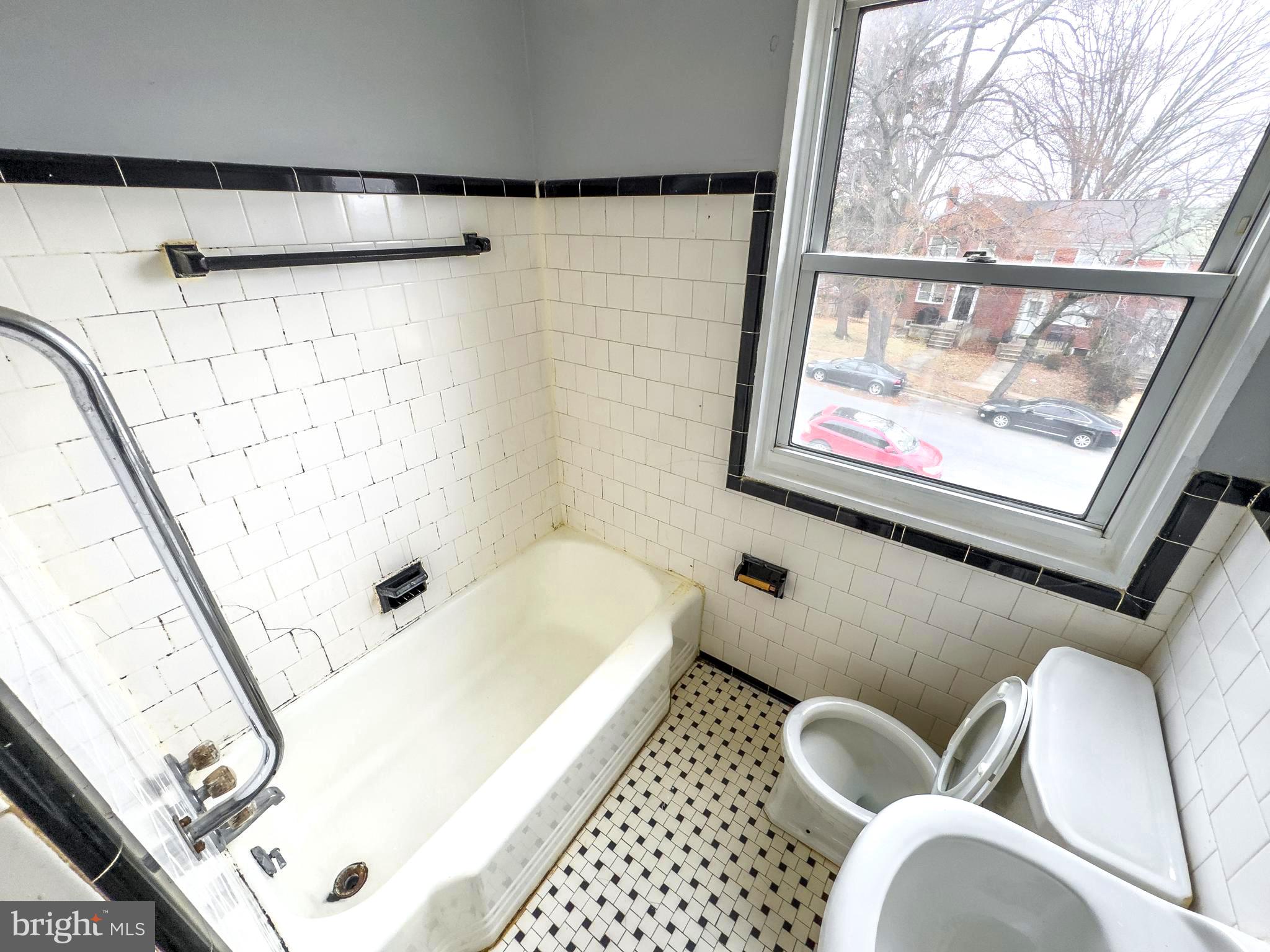 5515 Channing Road Baltimore, MD 21229 - Photo 7 of 10 a bathroom with a bathtub and shower