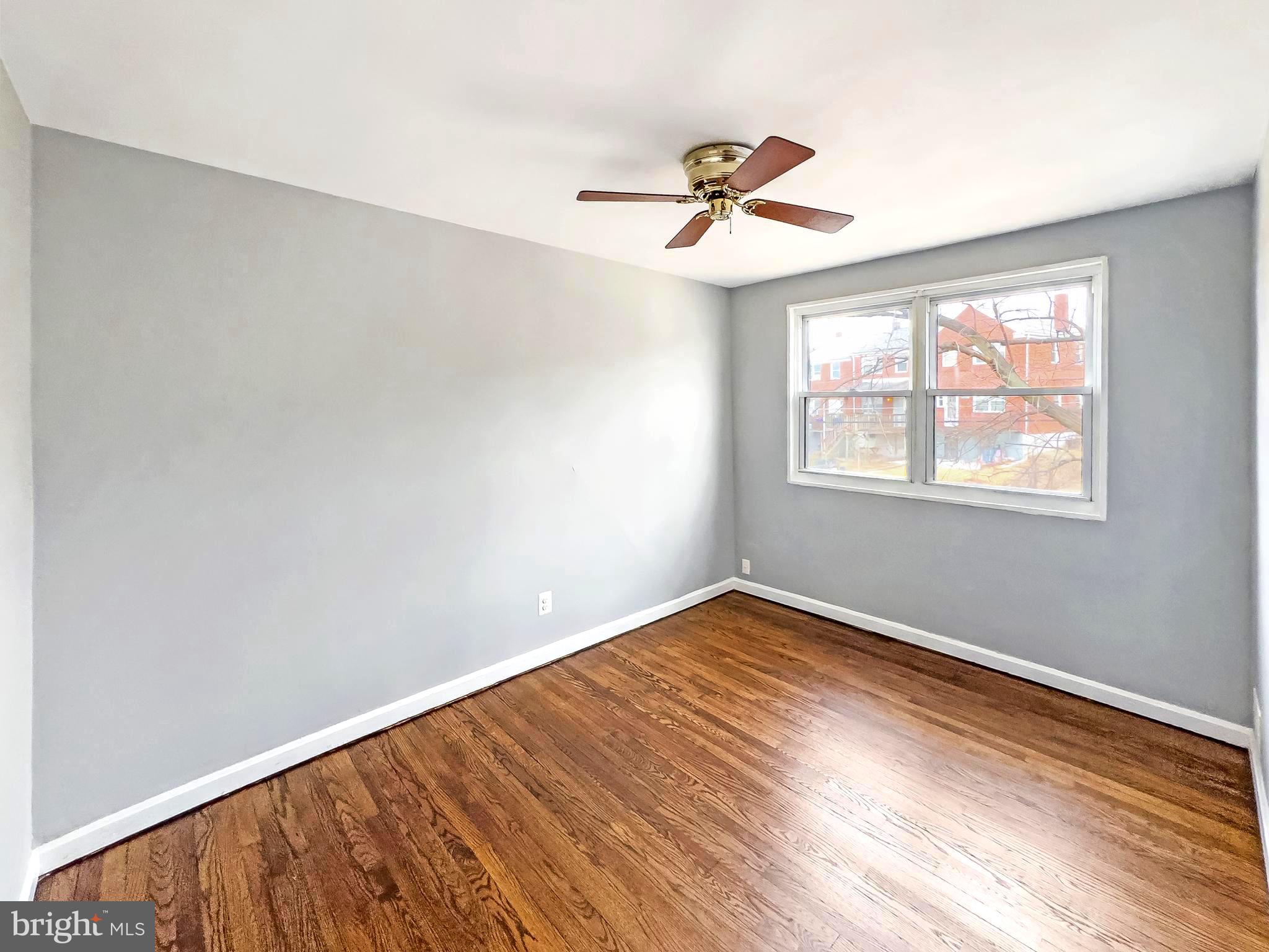 5515 Channing Road Baltimore, MD 21229 - Photo 9 of 10 a view of empty room with wooden floor and fan