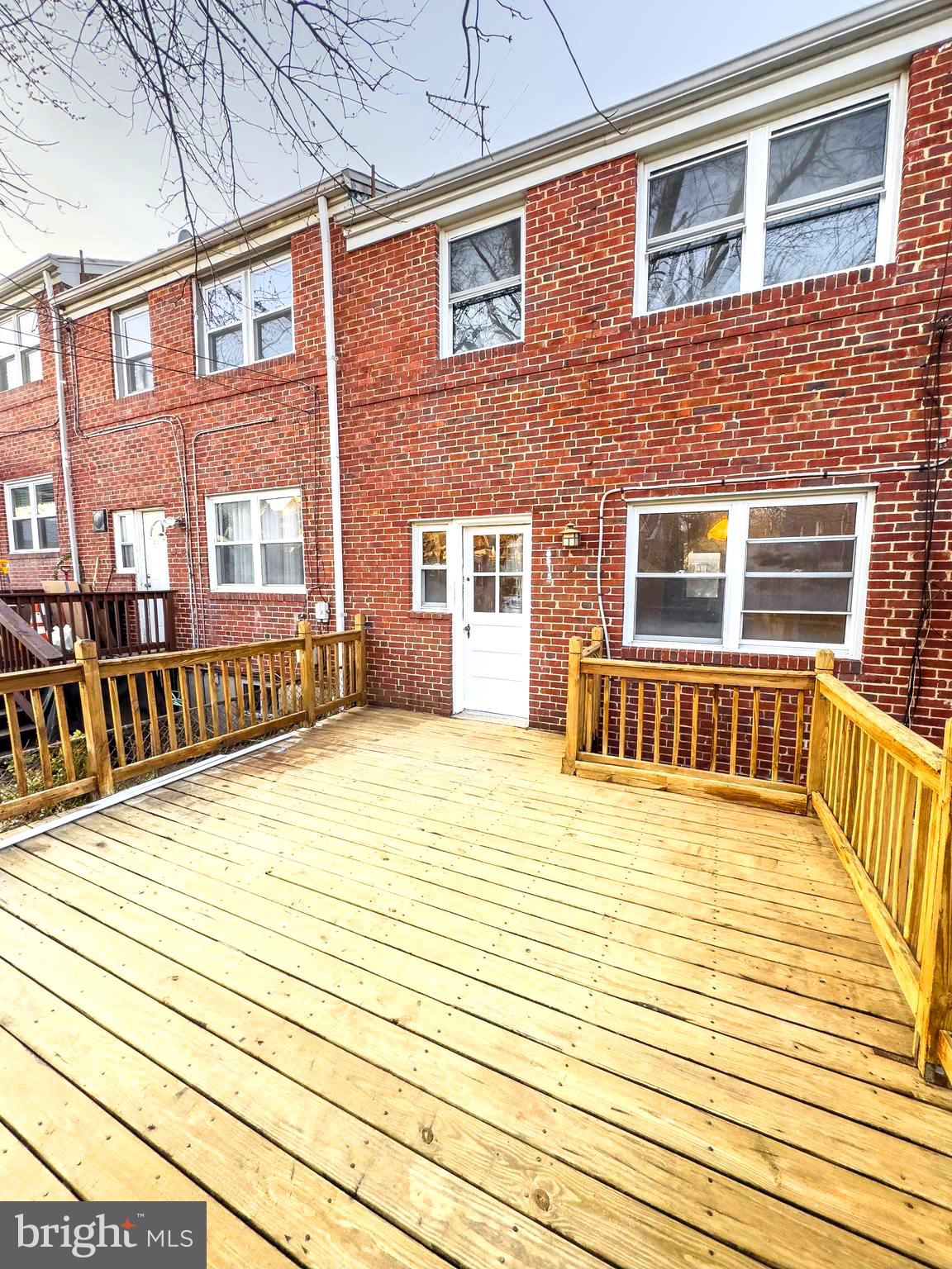 5515 Channing Road Baltimore, MD 21229 - Photo 10 of 10 a view of a house with a barbeque and wooden floor