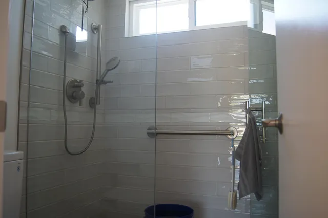 a bedroom with a bed and a potted plant