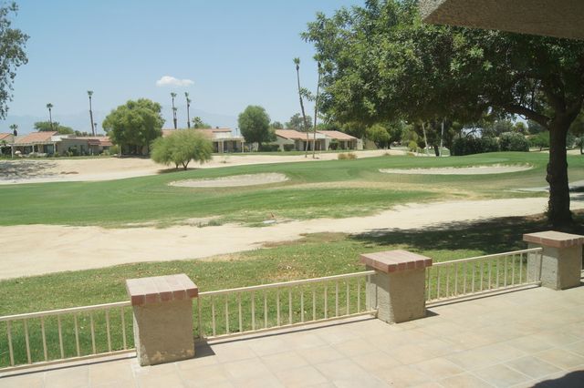 a view of a park with swings and slides