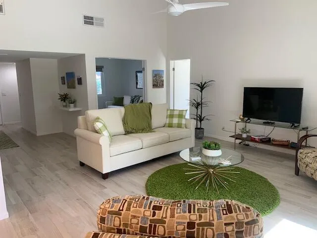 a living room with furniture and a large window