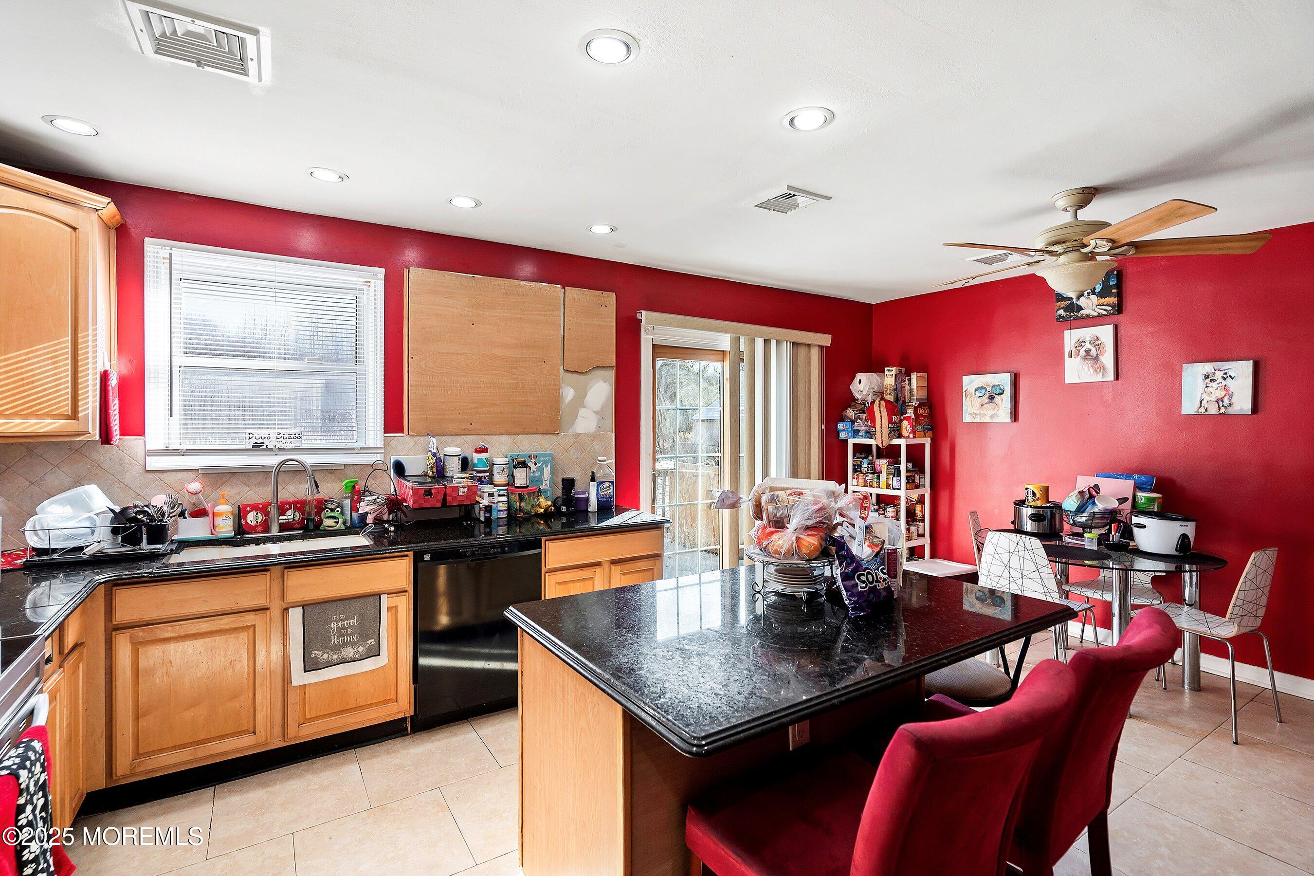 319 Jackson Mills Road Freehold, NJ 07728 - Photo 11 of 30 a kitchen with a table chairs stove and cabinets