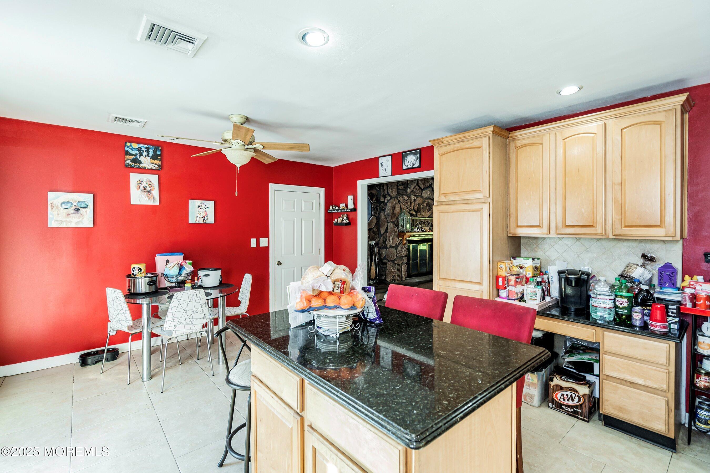 319 Jackson Mills Road Freehold, NJ 07728 - Photo 12 of 30 a kitchen with stainless steel appliances granite countertop a sink dishwasher and cabinets with wooden floor