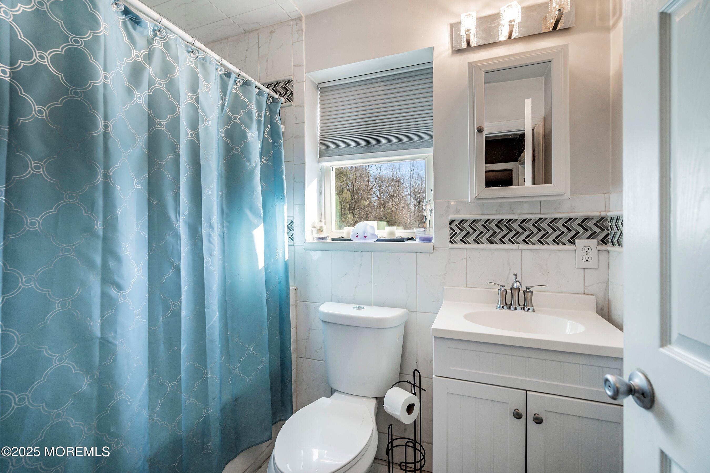 319 Jackson Mills Road Freehold, NJ 07728 - Photo 19 of 30 a bathroom with a toilet a sink and a mirror