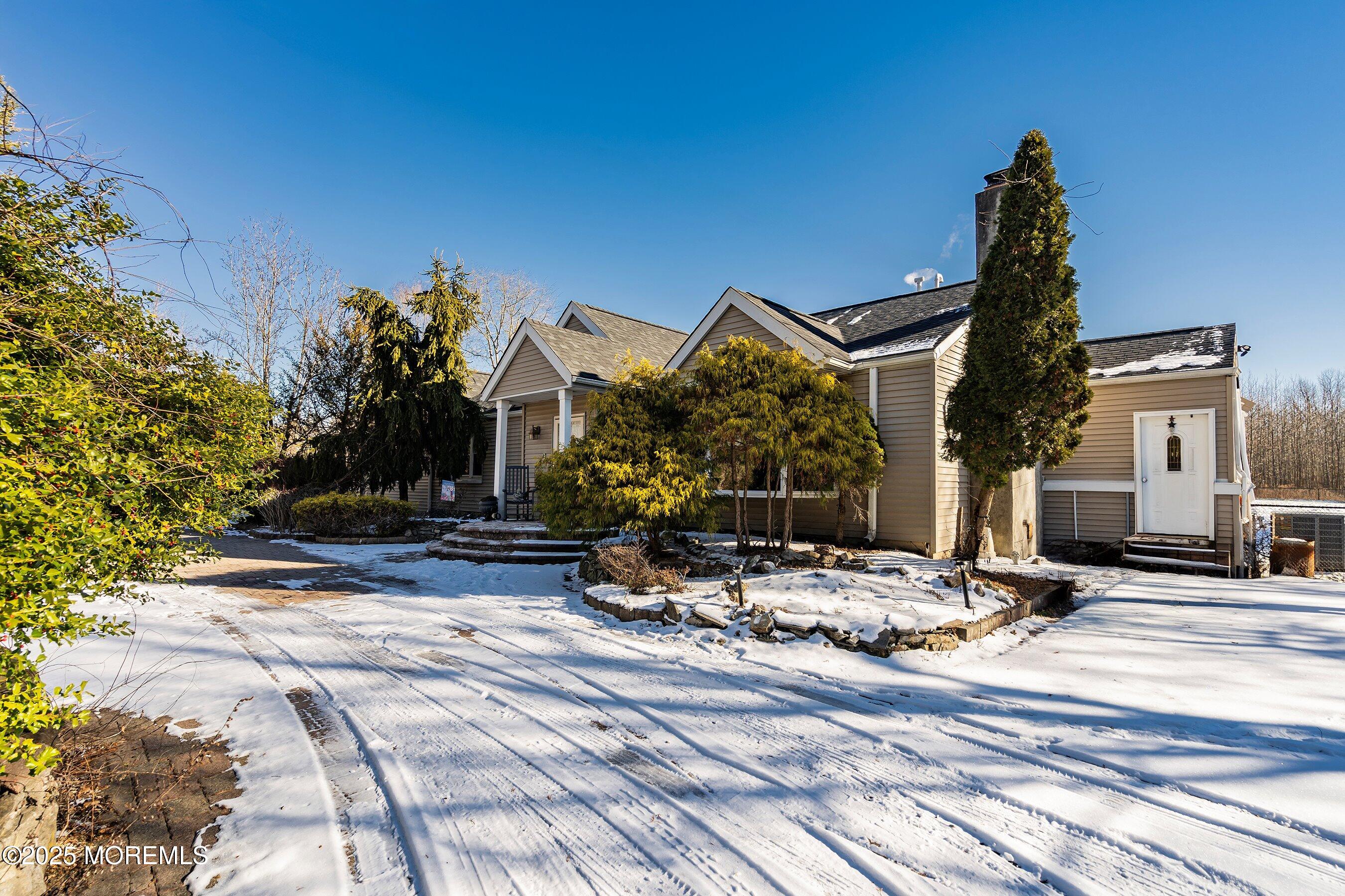 319 Jackson Mills Road Freehold, NJ 07728 - Photo 4 of 30 a view of a house with snow on the side of the road