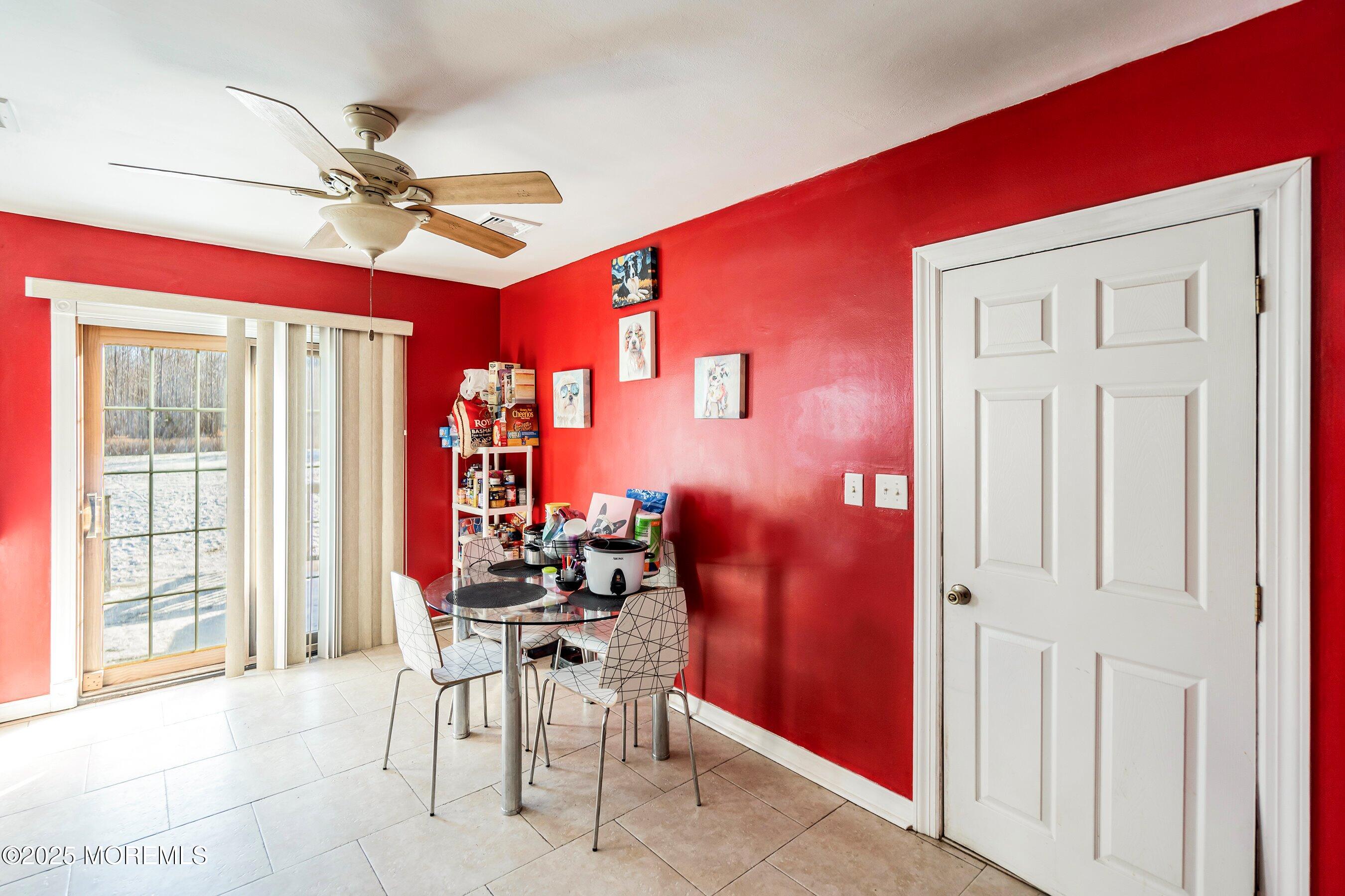 319 Jackson Mills Road Freehold, NJ 07728 - Photo 8 of 30 a dining room with furniture and a chandelier fan
