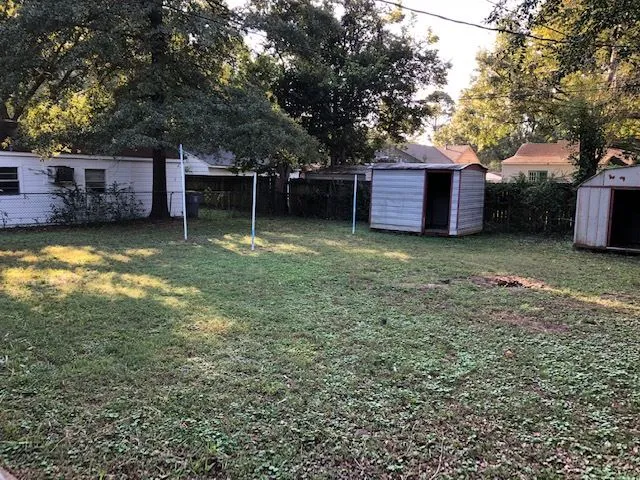a backyard of a house with yard basket ball court and outdoor seating