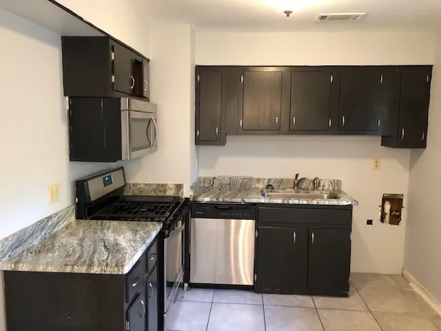 a kitchen with a stove and a microwave