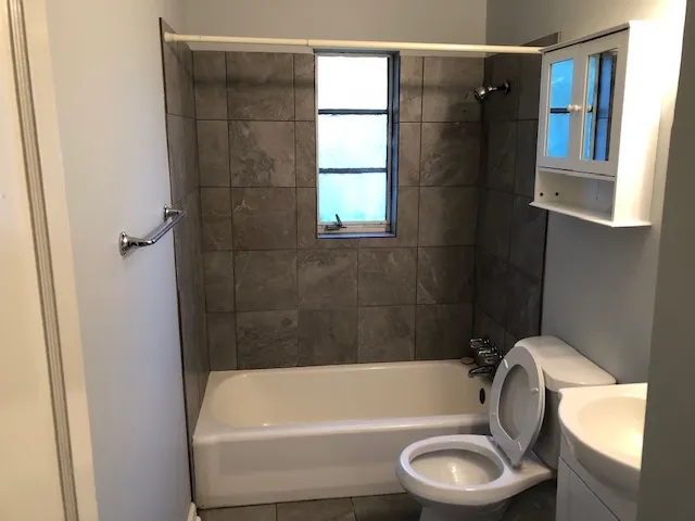 a bathroom with a toilet and a tub