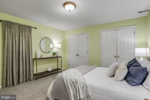 a bedroom with a large bed and a closet