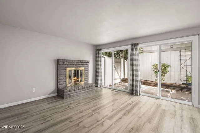 an empty room with wooden floor and a window