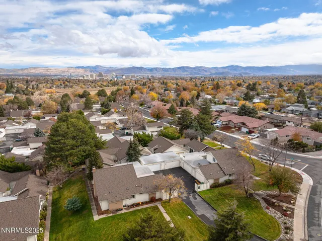 an aerial view of residential houses with outdoor space