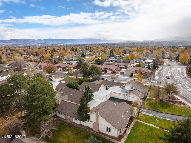 an aerial view of residential houses with outdoor space and ocean view