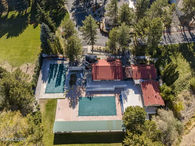 an aerial view of a house with a yard basket ball court and outdoor seating