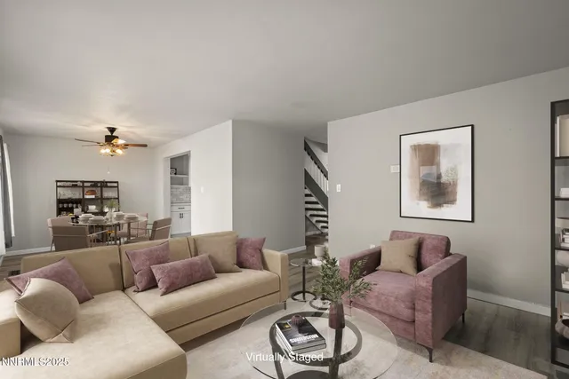 a living room with furniture a rug and a window
