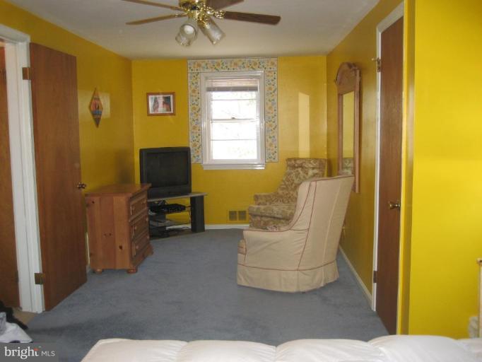 8710 Edmonston Road Berwyn Heights, MD 20740 - Photo 6 of 13 a living room with furniture and a window