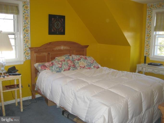 8710 Edmonston Road Berwyn Heights, MD 20740 - Photo 7 of 13 a bedroom with a bed and a cabinets
