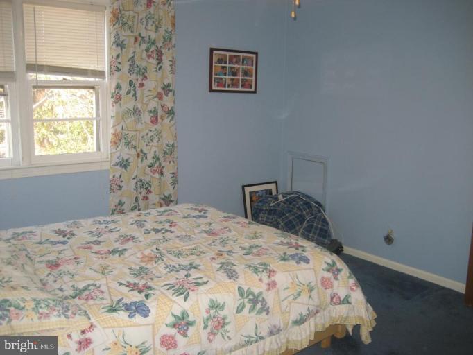 8710 Edmonston Road Berwyn Heights, MD 20740 - Photo 8 of 13 a bedroom with a bed and a window