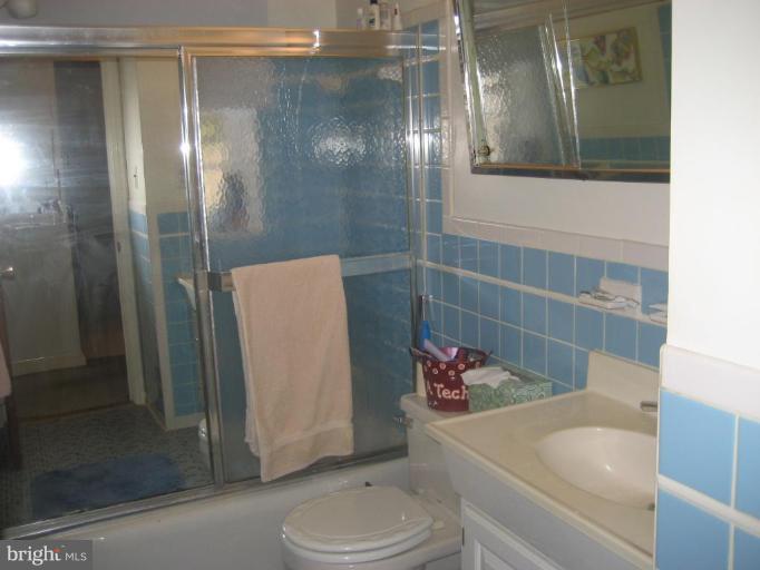 8710 Edmonston Road Berwyn Heights, MD 20740 - Photo 10 of 13 a bathroom with a sink and a mirror