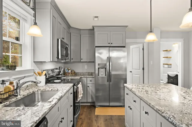 a kitchen with a sink stove and refrigerator