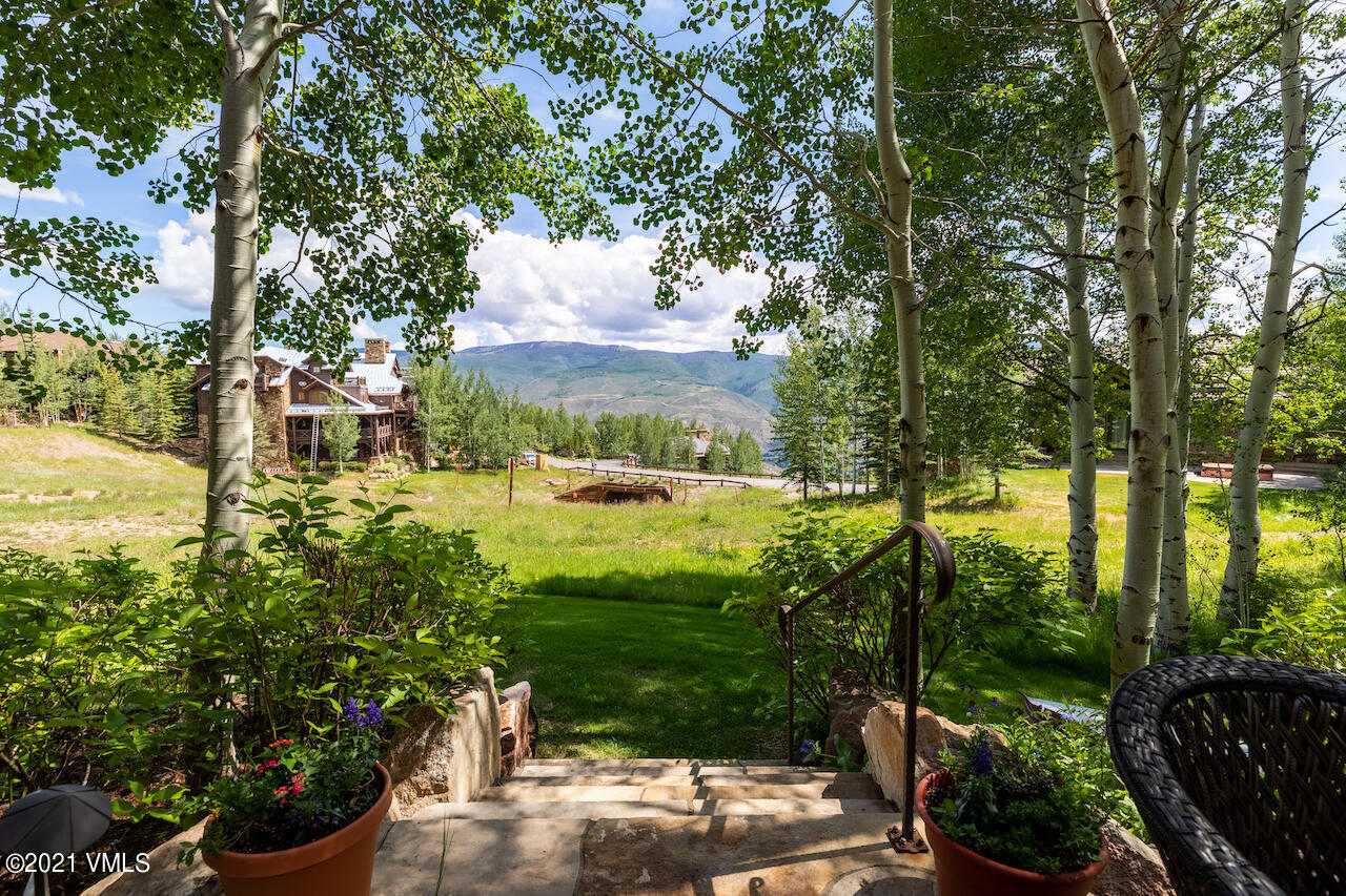 110 Bear Paw, Unit A Avon, CO 81620 - Photo 17 of 19 a view of a garden with a bench
