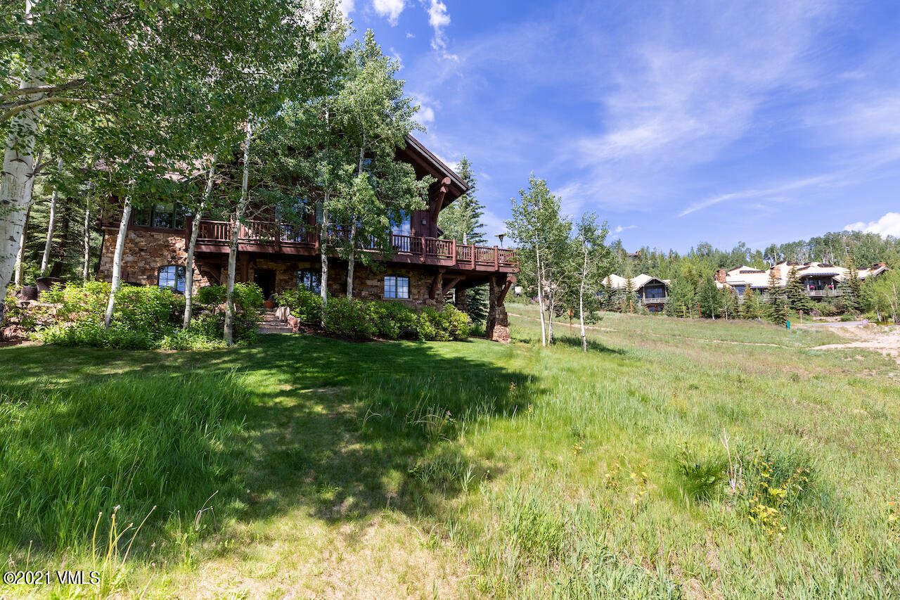 110 Bear Paw, Unit A Avon, CO 81620 - Photo 18 of 19 a view of a house with a big yard potted plants and large tree