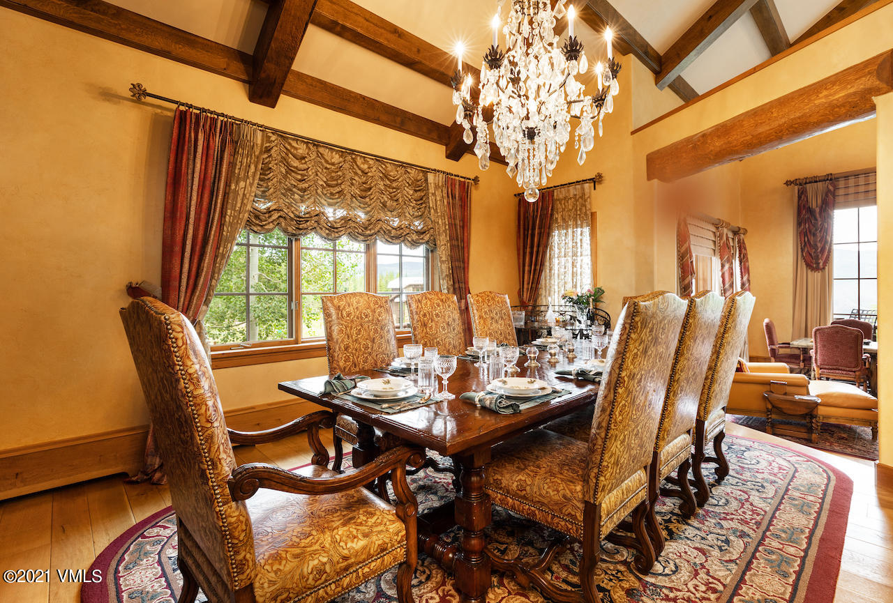 110 Bear Paw, Unit A Avon, CO 81620 - Photo 4 of 19 a dining room with furniture a chandelier and wooden floor