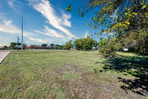 a view of a field with an trees