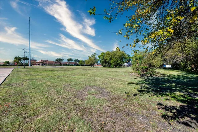 a view of a field with an trees